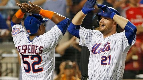 New York Mets Yoenis Cespedes, (52), greets New York Mets Lucas Duda at the plate after scoring on Duda's third-inning, two-run, home run during a baseball game against the Washington Nationals in New York, Sunday, Aug. 2, 2015. (AP Photo/Kathy Willens)