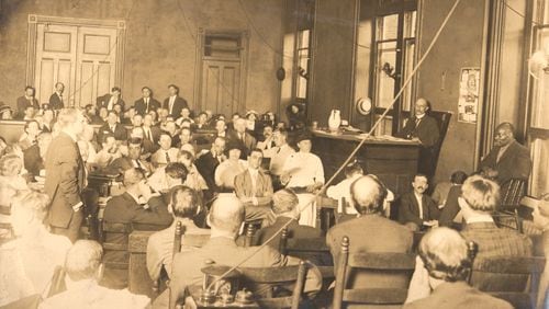 This photo shows prosecutor Hugh Dorsey, standing at left during the trial of Leo Frank, who is seated at center. This photo from the Frank trial was shot by Walter Winn in 1913. Winn's grandson, Walter Winn of Decatur, said this image and many others from Winn's career have been handed down to succeeding generations of the family.