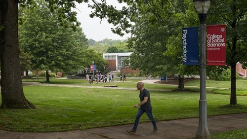 A man walks the campus at the University of West Georgia in Carrollton. The plot of land to the right of the man is where recent archaeological tests suggest slaves from a former plantation might be buried. If true, UWG will be added to a long list of colleges and communities challenged with questions on how to deal with newly discovered remains of former slaves and Reconstruction-era African Americans. (ALYSSA POINTER/ALYSSA.POINTER@AJC.COM)
