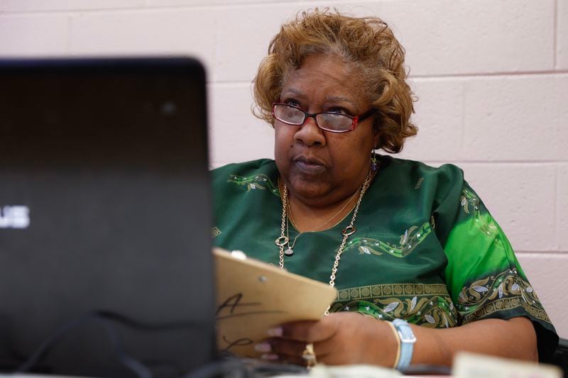 Gloria Simmons, president of the University Bridge Club ,works on her computer as members play during the club’s weekly game at Quality Living Services in Atlanta.  (Natrice Miller/natrice.miller@ajc.com) 
