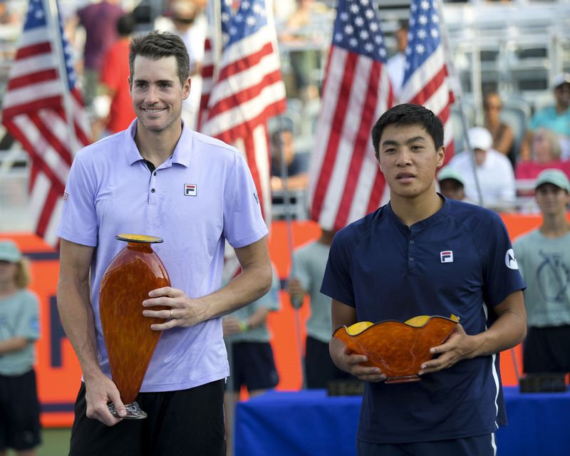 U.S. tennis players John Isner (left) and Brandon Nakashima pose with their trophies after competing in the Truist Atlanta Open Sunday, Aug. 1, 2021 at Atlantic Station in Atlanta. Isner won his sixth Atlanta Open. (Daniel Varnado/For the AJC)