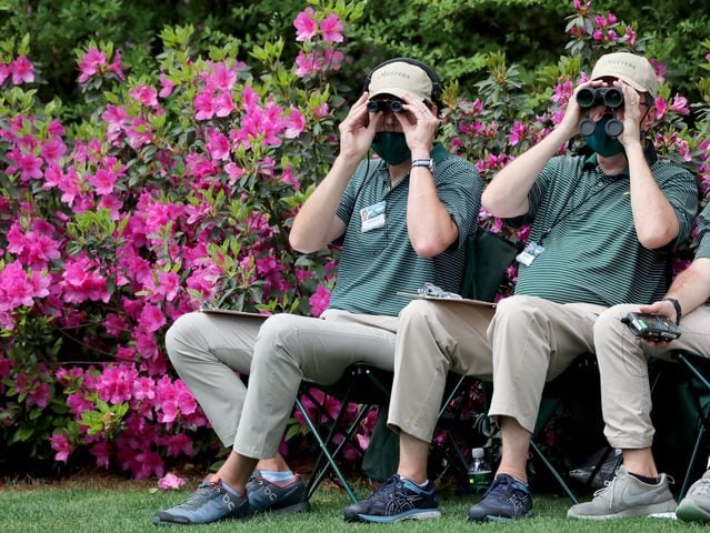 April 9, 2021, Augusta: Course workers follow the action on the thirteenth hole during the second round of the Masters at Augusta National Golf Club on Friday, April 9, 2021, in Augusta. Curtis Compton/ccompton@ajc.com