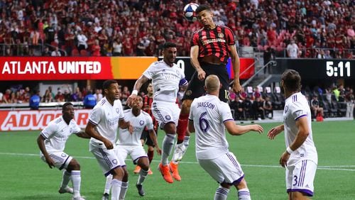 Atlanta United defender Miles Robinson trys to head a corner kick into the net against a host of Orlando City defenders during the first half in a MLS soccer match on Sunday, May 12, 2019, in Atlanta.  Curtis Compton/ccompton@ajc.com