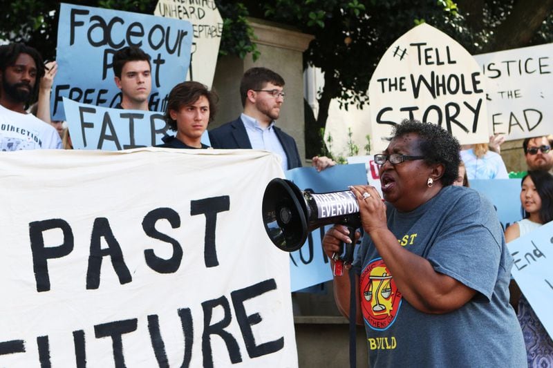 Linda Lloyd, director of the Economic Justice Coalition, speaks at a rally of current and former University of Georgia students, faculty and community activists at the arch on May 6, 2019, in Athens. The demonstrators have pushed the school to offer various forms of reparations to address how, they say, the university has taken advantage of descendants of enslaved peoples, pay a higher working wage for university employees and give justice to the slaves who were found buried below Baldwin Hall. 