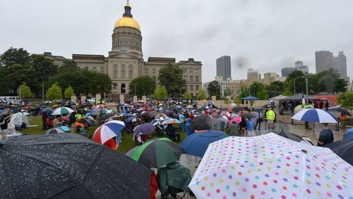 Several hundred people defied the rain to attend “We Stand with God Pro-Family Rally” on Liberty Plaza across from the Georgia Capitol on Friday, April 22, 2016. Less than a month after Gov. Nathan Deal vetoed a controversial “religious liberty” bill, a leading legislative proponent, ministers and other backers were holding a “We Stand with God” rally across from The Georgia State Capitol. HYOSUB SHIN / HSHIN@AJC.COM