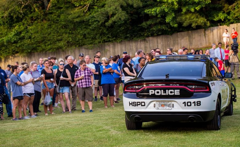 Members of the Holly Springs community and neighboring police departments gather at Barrett Park for a candlelight vigil for Police Officer Joe Burson on Friday, June 18, 2021 after he was killed during a traffic stop earlier this week.(Jenni Girtman for The Atlanta Journal-Constitution)