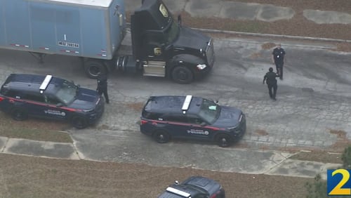 A UPS driver was kidnapped at gunpoint and tied up while a group of people stole cargo from a tractor-trailer, according to Atlanta police.
