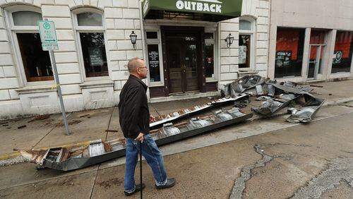 SAVANNAH: A man walks past debris from a damaged building in historic downtown Savannah in the aftermath of Hurricane Matthew on Saturday, Oct. 8, 2016. Curtis Compton /ccompton@ajc.com
