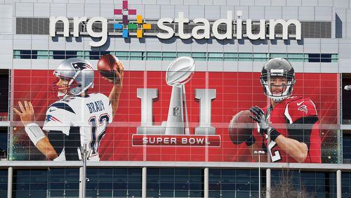 No doubt who the headliners are in this Super Bowl, as this giant likeness of the Falcons Matt Ryan and the Pats Tom Brady at the entrance to NRG Stadium will attest. (Curtis Compton/ccompton@ajc.com)