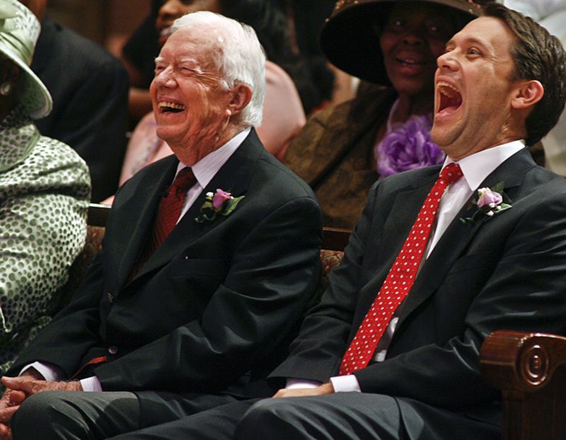 Former President Jimmy Carter, left, and his grandson, Jason Carter, react to a joke from the pulpit in 2014 at Mt. Zion Baptist Church in Albany. (AP Photo/Phil Sears)
