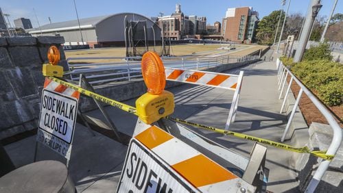Sidewalks are blocked off between the track and the Molecular Science and Engineering building at Georgia Tech on Wednesday. Georgia Tech warned students and staff to be on alert after a rabid fox attacked students on campus. Four students have been treated for rabies.