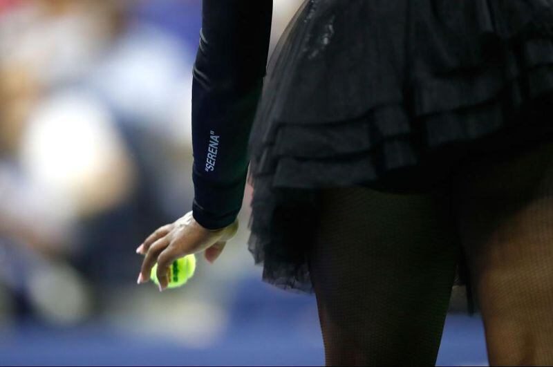 Tennis pro Serena Williams prepares to serve the ball during her women's singles first round match against Magda Linette of Poland. Williams’  black ruffled tutu made a splash at the U.S. Open after her Nike catsuit was banned from the French Open earlier this year.