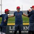 Braves second baseman Ozzie Albies (from left), first baseman Matt Olson and third baseman Austin Riley chat as they warm up during spring training workouts at CoolToday Park, Monday, February, 19, 2024, in North Port, Florida. (Hyosub Shin / Hyosub.Shin@ajc.com)