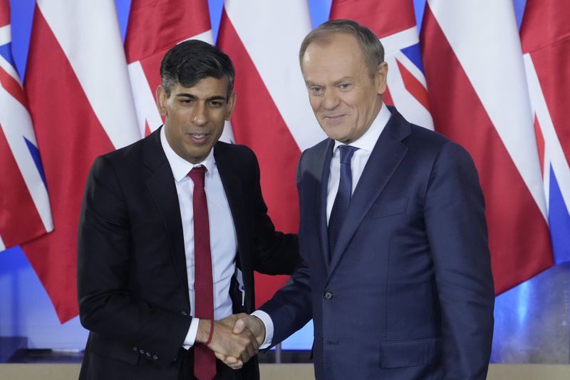 Polish Prime Minister Donald Tusk, right, and Britain's Prime Minister Rishi Sunak pose at the Prime Minister Office in Warsaw, Poland, Tuesday, April 23, 2024. Sunak will hold talks with Tusk and Stoltenberg that will focus on Ukraine and wider European security. (AP Photo/Czarek Sokolowski)