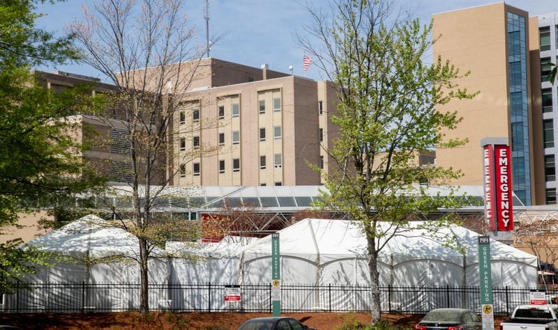 The newly constructed tents stand outside of Northside Hospitals' Emergency Department are built in anticipation of a surge of COVID-19 patients march 30, 2020. STEVE SCHAEFER / SPECIAL TO THE AJC