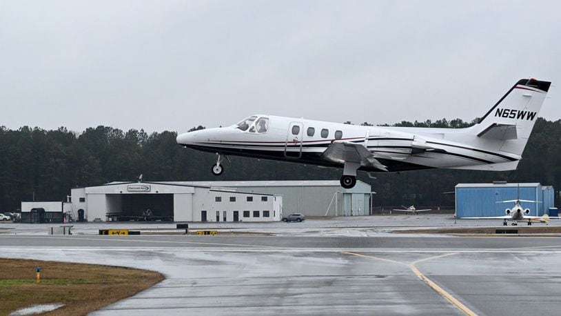 Beechcraft B55 airplane takes off as Fixed Base Operator (FBO) is shown in background at The Gwinnett County Airport - Briscoe Field, Thursday, Jan. 19, 2023, in Lawrenceville. The Gwinnett County Airport - Briscoe Field is located on approximately 500 acres northeast of the city of Lawrenceville. (Hyosub Shin / Hyosub.Shin@ajc.com)