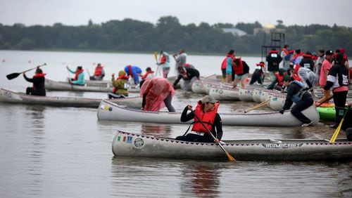 The first wave of women set off from shores of Bde Maka Ska/Lake Calhoun by canoe during the Kwe Strong Triathlon, which aims to bring indigenous women together through health and wellness, on August 26, 2017, in Minneapolis. (David Joles/Minneapolis Star Tribune/TNS)