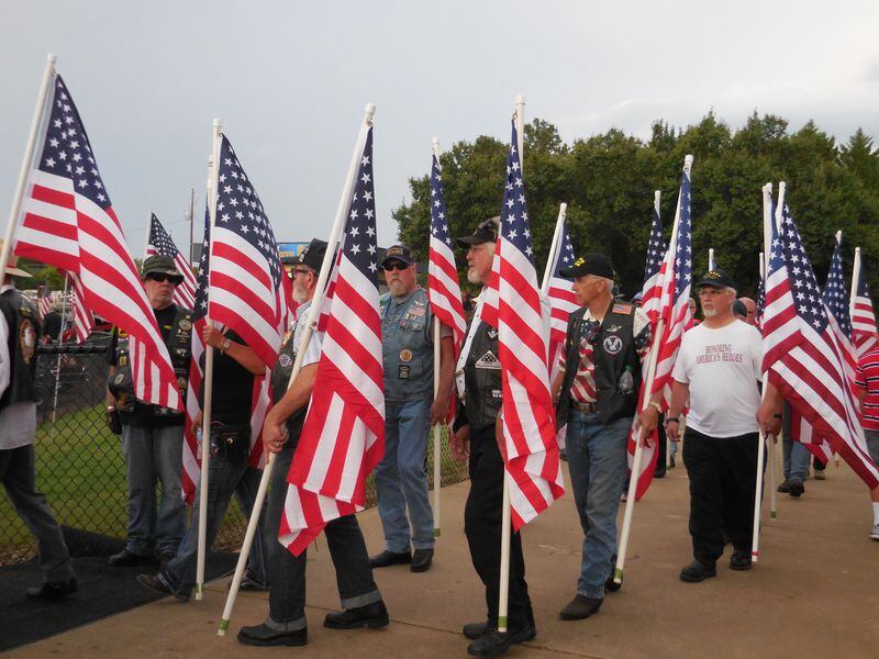 An honor guard lines the path to the Sprayberry stadium with flags. Photo: Jennifer Brett