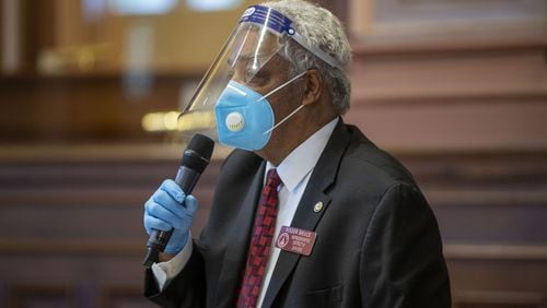 Georgia Rep. Roger Bruce, D-Atlanta, wears a face shield, gloves and mask while speaking in favor a bill after the General Assembly returned this month to complete the session it suspended in mid-March because of the coronavirus pandemic. (ALYSSA POINTER / ALYSSA.POINTER@AJC.COM)