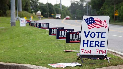 Hill and Kemp campaign signs line Canton Road leading up to the polling location at Noonday Baptist Church in Marietta, Georgia, on Tuesday, May 22, 2018. (REANN HUBER/REANN.HUBER@AJC.COM)