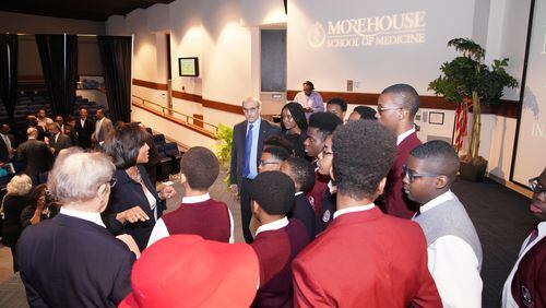 Morehouse School of Medicine president Dr. Valerie Montgomery Rice, wearing black blazer, and 2008 Nobel Prize winner Dr. Martin Chalfie, wearing blue tie, speak with students from Fulton Leadership Academy, who heard his lecture on Tuesday, March 27, 2018. PHOTO CONTRIBUTED