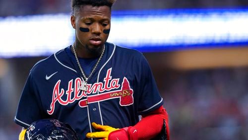 Atlanta Braves' Ronald Acuna Jr. walks off the field after grounding out and stranding two runners during the eighth inning of the team's baseball game against the Texas Rangers in Arlington, Texas, Saturday, April 30, 2022. The Rangers won 3-1. (AP Photo/LM Otero)