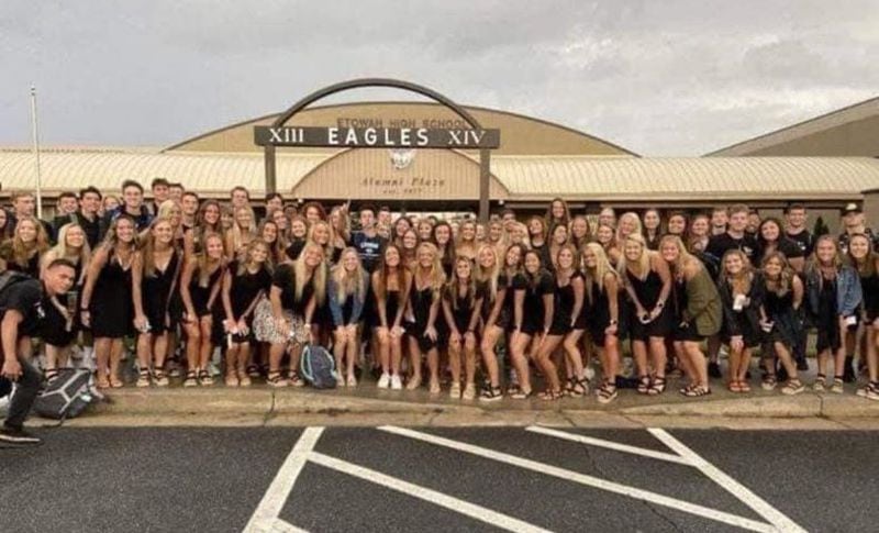 Seniors at Etowah High School in Cherokee County posed for the traditional color-coordinated senior photo on Aug, 3, 2020, the first day back to classes in the COVID era. The photo went viral because the students are not wearing masks and crowded together for the shot.