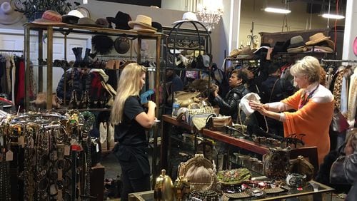 About 100 shoppers arrived before the doors opened on the first day of the Diane McIver estate sale which featured hundreds of items of clothing, shoes and accessories. The five-day sale runs through Sunday, when any remaining items will be priced at 50 percent off.