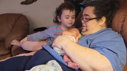 Amanda Jones holds her newborn daughter, Miranda, at their home in Macon in December 2022, and her toddler, Katie. Jones died in June 2023. Jones and similar women's deaths are reviewed by the state to determine if they were caused by pregnancy. (Contributed)