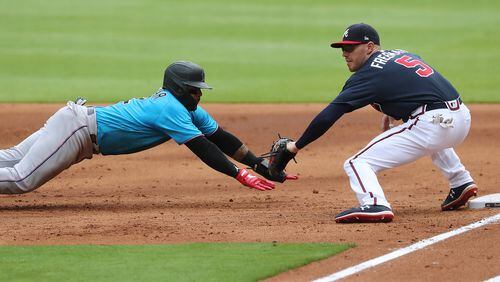 072220 Atlanta: Atlanta Braves Freddie Freeman picks off Miami Marlins Jonathan Villar at first base on a throw from pitcher Kyle Wright during the third inning in an exhibition game on Wednesday, July 22, 2020 in Atlanta.   Curtis Compton ccompton@ajc.com