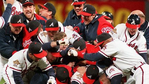 Braves players celebrate winning the 1995 World Series title in Game 6 over the Cleveland Indians Oct. 28, 1995, in Atlanta.