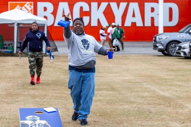Brian Warrel, a Howard University fan, plays Cornhole at the Home Depot Backyard in Downtown Atlanta before the start of the Celebration Bowl last December. The fan-friendly site opened in 2018 after the Falcons moved to Mercedes-Benz Stadium, and has since served as a flexible space for pop-up events each year, including flashbulb affairs that cater to Atlanta's professional sports teams. Photo by Steve Schaefer/steve.schaefer@ajc.com