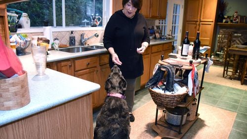 Toni Appling, shown giving a treat to her dog Miss Maeve at her home in Johns Creek, is known for her dog rescue work, but now she’s the one who needs help. Appling’s kidneys are failing, so she needs a transplant. HYOSUB SHIN / HYOSUB.SHIN@AJC.COM