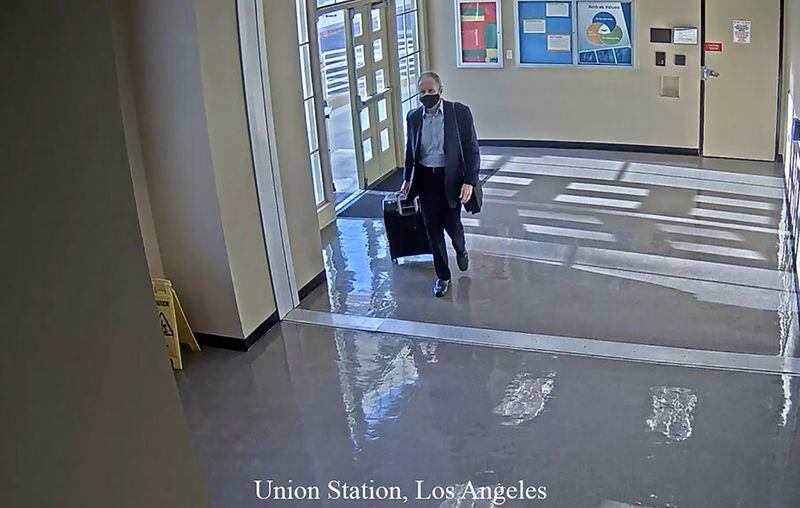 This July 11, 2020 surveillance photo provided by the San Bernardino County Sheriff’s Department shows a man who they believe is Roy Den Hollander walking through Union Station in Los Angeles.
