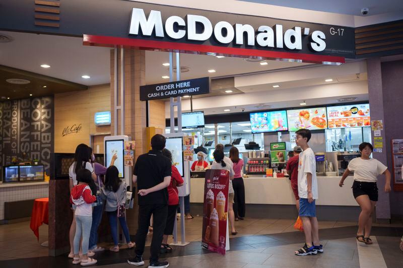 Customers place orders at a McDonald's restaurant at a shopping mall in Kuala Lumpur, Malaysia, Sunday, April 28, 2024. McDonald's releases its first quarter earnings Tuesday, April 30, 2024. (AP Photo/Vincent Thian)