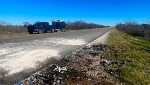Debris from a fatal crash can be seen on U.S. 67 in Johnson County, Texas, on Wednesday. Three people from Alpharetta, including two children, were among the six killed.