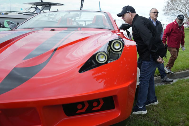 Former Maryland Gov. Larry Hogan looks at a JetCar while visiting the Bridge Boat Show in Stevensville, Md., Friday, April 12, 2024, as he campaigns for the U.S. Senate. (AP Photo/Susan Walsh)