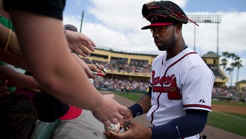 Braves outfielder Jason Heyward signs autographs for fans Sunday before Atlanta played the Miami Marlins in a spring training exhibition game.