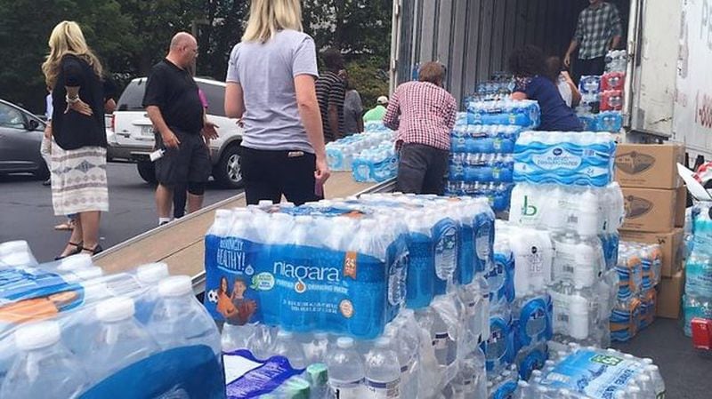 Volunteers prepare packages of bottled water to be delivered from Atlanta to Houston after Hurricane Harvey.