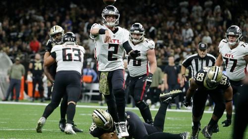Falcons quarterback Matt Ryan steps out of a potential sack and delivers against the Saints Sunday. (AP Photo/Butch Dill)