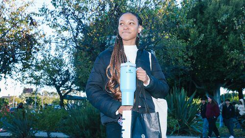Kimora Johnson poses for a portrait with a Stanley Cup branded water bottle outside her high school in Culver City. She recently purchased the cup, which has been selling out at retailers, from Urban Outfitters. (Dania Maxwell/Los Angeles Times/TNS)