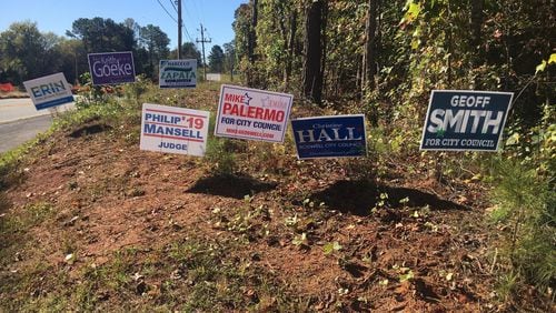These were some of the 57 campaign signs bordering the East Roswell Library, on Wednesday, Oct. 23, 2019. The library is one of the city’s two early voting locations. Election day is Nov. 5, 2019. (Ben Brasch/AJC)
