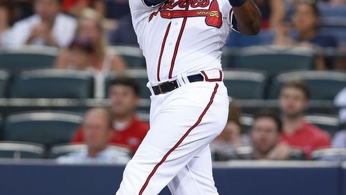 ATLANTA, GA - AUGUST 15: Left fielder Justin Upton #8 of the Atlanta Braves hits a solo home run in the second inning of the game against the Oakland Athletics at Turner Field on August 15, 2014 in Atlanta, Georgia. (Photo by Mike Zarrilli/Getty Images)