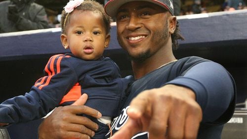 Ozzie Albies holds his sister Jeanalyn before Monday night’s game against the Yankees. (Curtis Compton/ccompton@ajc.com)
