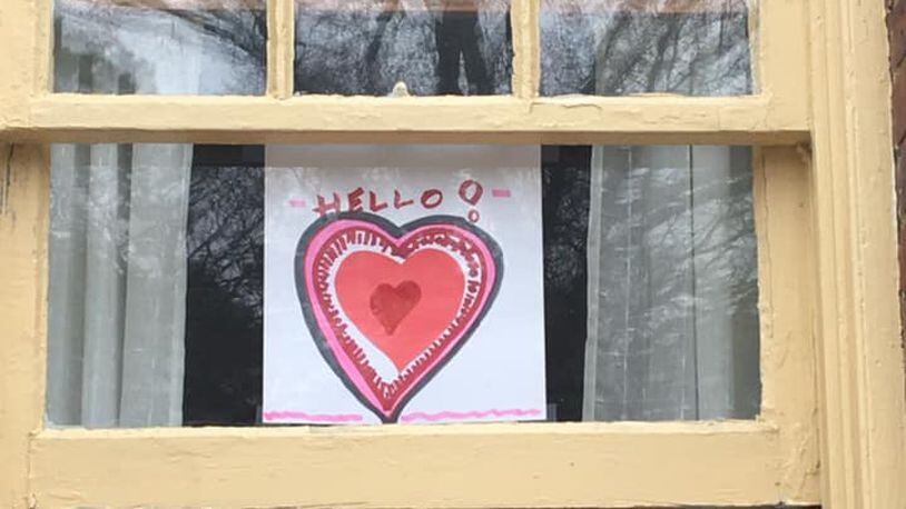 People across metro Atlanta have been hanging encouraging messages on windows, even as we all practice social distancing. This window display is in East Point. (Contributed)