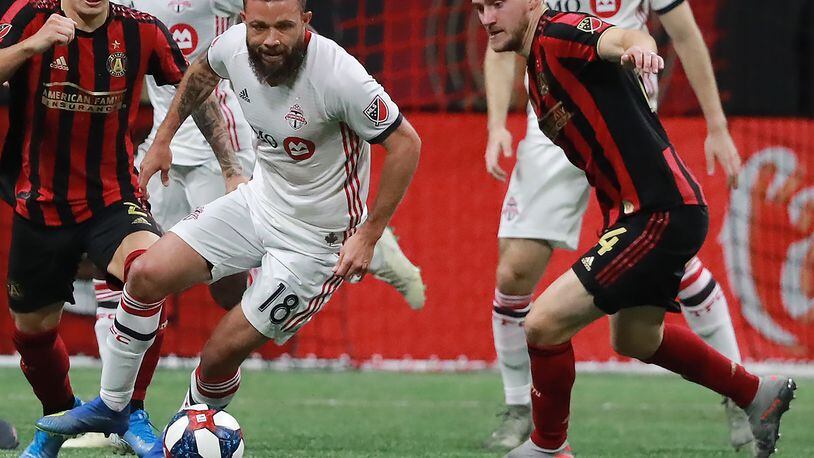 October 30, 2019 Atlanta: Toronto FC midfielder Nick DeLeon takes the ball away from Atlanta United midfielder Julian Gressel (right) and scores the winning goal for a 2-1 victory in the Eastern Conference Final on Wednesday, October 30, 2019, in Atlanta.   Curtis Compton/ccompton@ajc.com