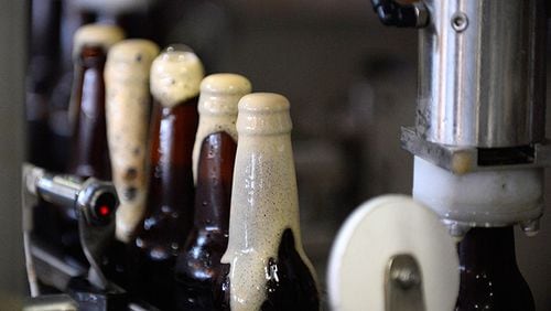 Bottles of Wild Heaven Brewery's Ode to Mercy brown ale are bottled and capped at the Decatur, Ga., brewery.