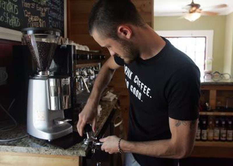 Matt Davis works behind the counter at the Land of 1000 Hills Coffee Co.