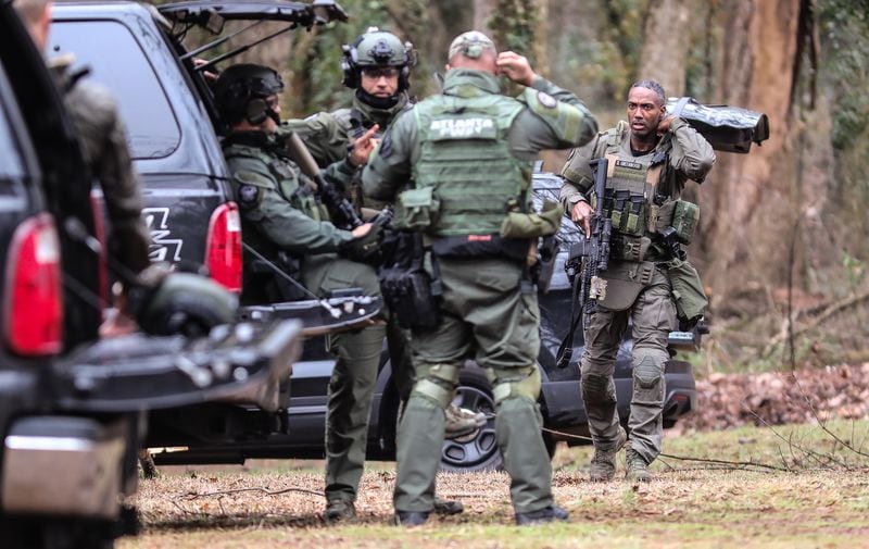 Members of the Atlanta police SWAT team gather at Gresham Park Wednesday morning, after a Georgia State Patrol trooper was shot near the site of Atlanta's proposed public safety training center.