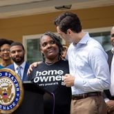 U.S. Sen. Jon Ossoff (right), D-Ga, stands with new homeowner Tanjills Sawyer at a press conference in Lovejoy on Monday, May 6, 2024. The conference, which announced federal funds for housing in Clayton County, took place in front of Sawyer’s house, built by Southern Crescent Habitat for Humanity. (Arvin Temkar / AJC)